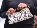 Nola & Eve Stormy Elegance clutch in black-and-white abstract brocade with bold red interior, handmade statement bag