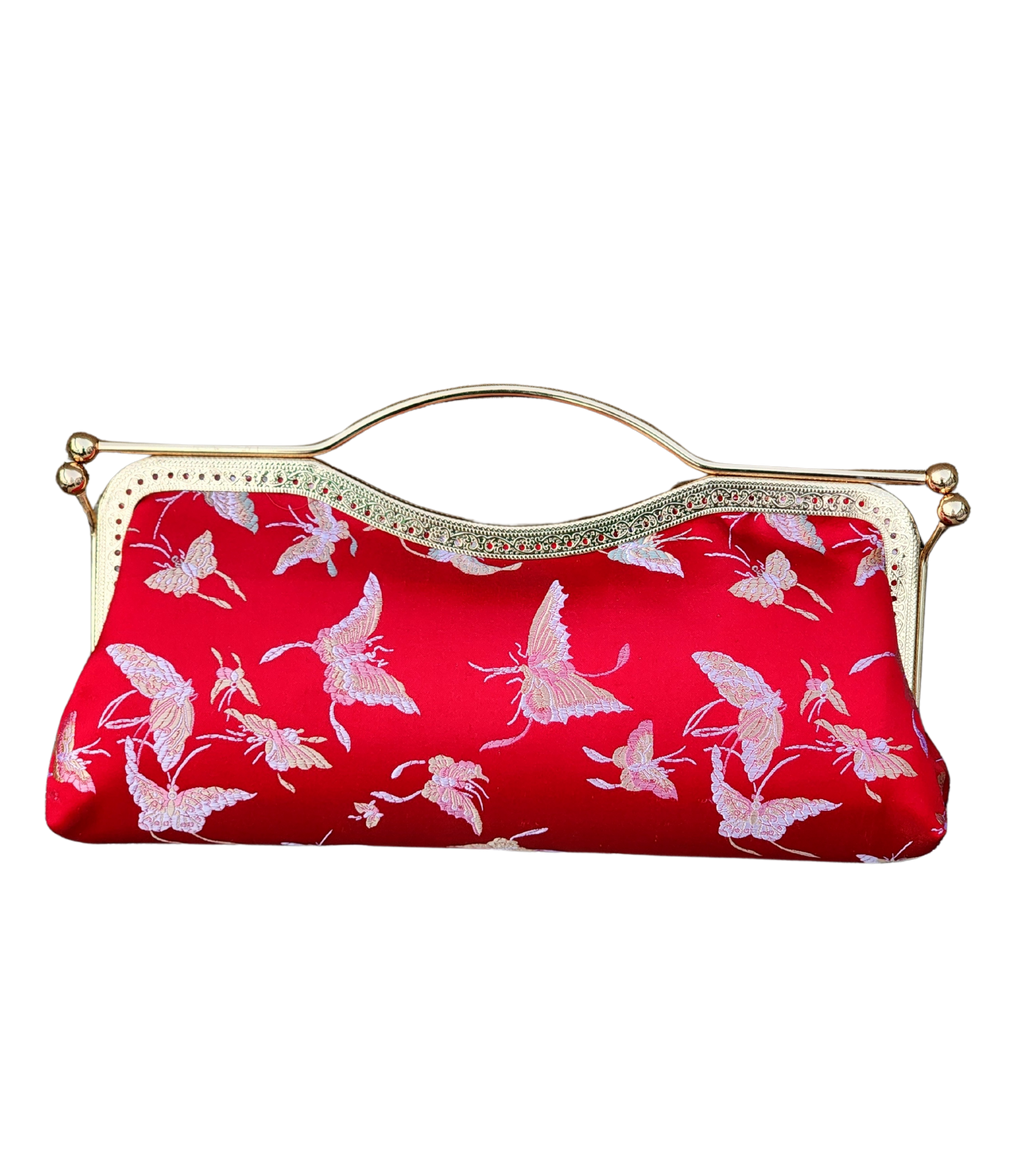 Nola & Eve Crimson Serenity clutch in vibrant red brocade with delicate butterfly embroidery, handmade limited-edition statement bag