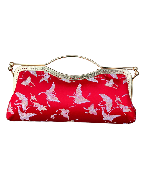 Nola & Eve Crimson Serenity clutch in vibrant red brocade with delicate butterfly embroidery, handmade limited-edition statement bag