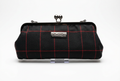 Nola & Eve Midnight Regent clutch in black fabric with crimson windowpane pattern and black metal kiss-lock frame, handmade limited-edition statement bag