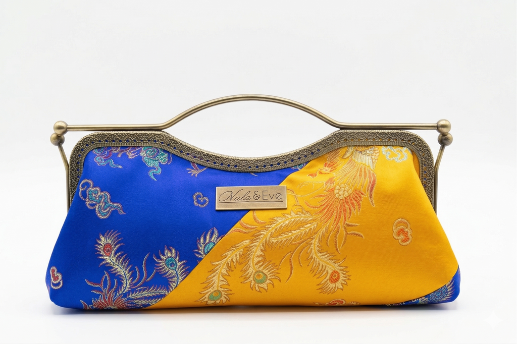 Nola & Eve Phoenix Dynasty Signature two-tone brocade clutch with gold ornate frame and phoenix-and-dragon detailing, limited-edition statement bag