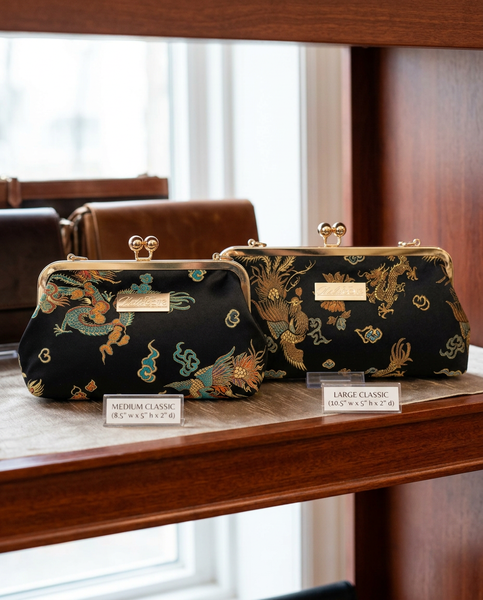 Phoenix Dynasty Classic brocade clutch by Nola & Eve, gold metal frame with top handle and phoenix-and-dragon design