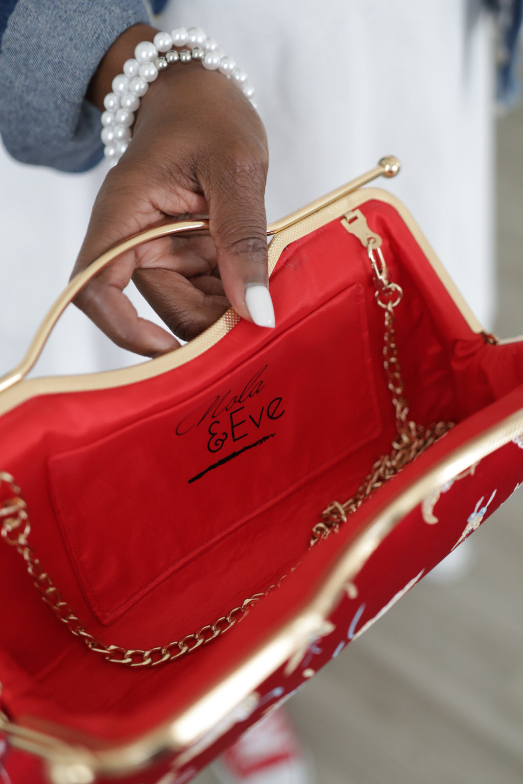 Crimson Serenity red brocade clutch by Nola & Eve with butterfly embroidery and crossbody chain strap