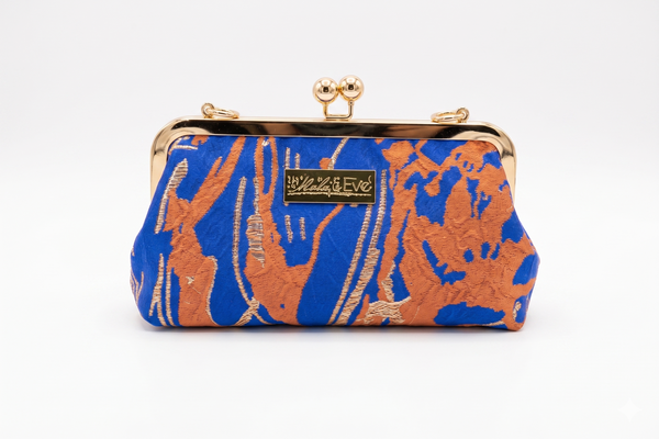 Desert Mirage Classic woven brocade clutch by Nola & Eve with structured frame and detachable chain strap