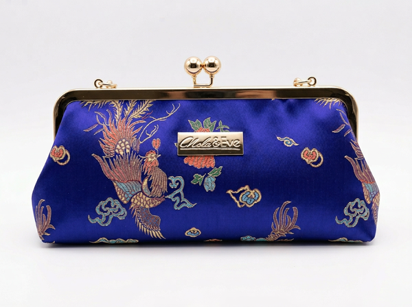 Phoenix Dynasty Classic brocade clutch by Nola & Eve, gold metal frame with top handle and phoenix-and-dragon design