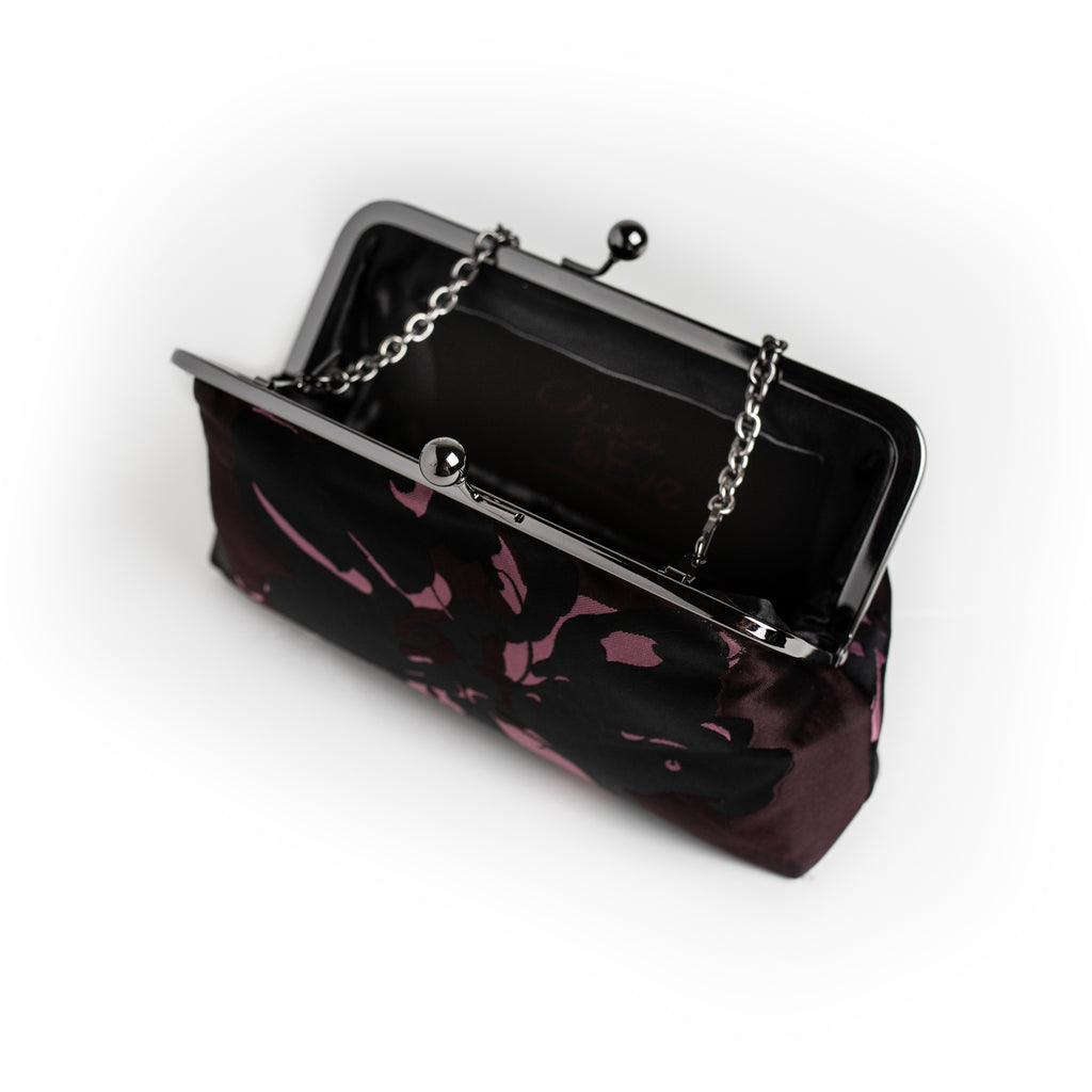 Black and Aubergine dual-tone floral brocade clutch by Nola & Eve with dual chain straps