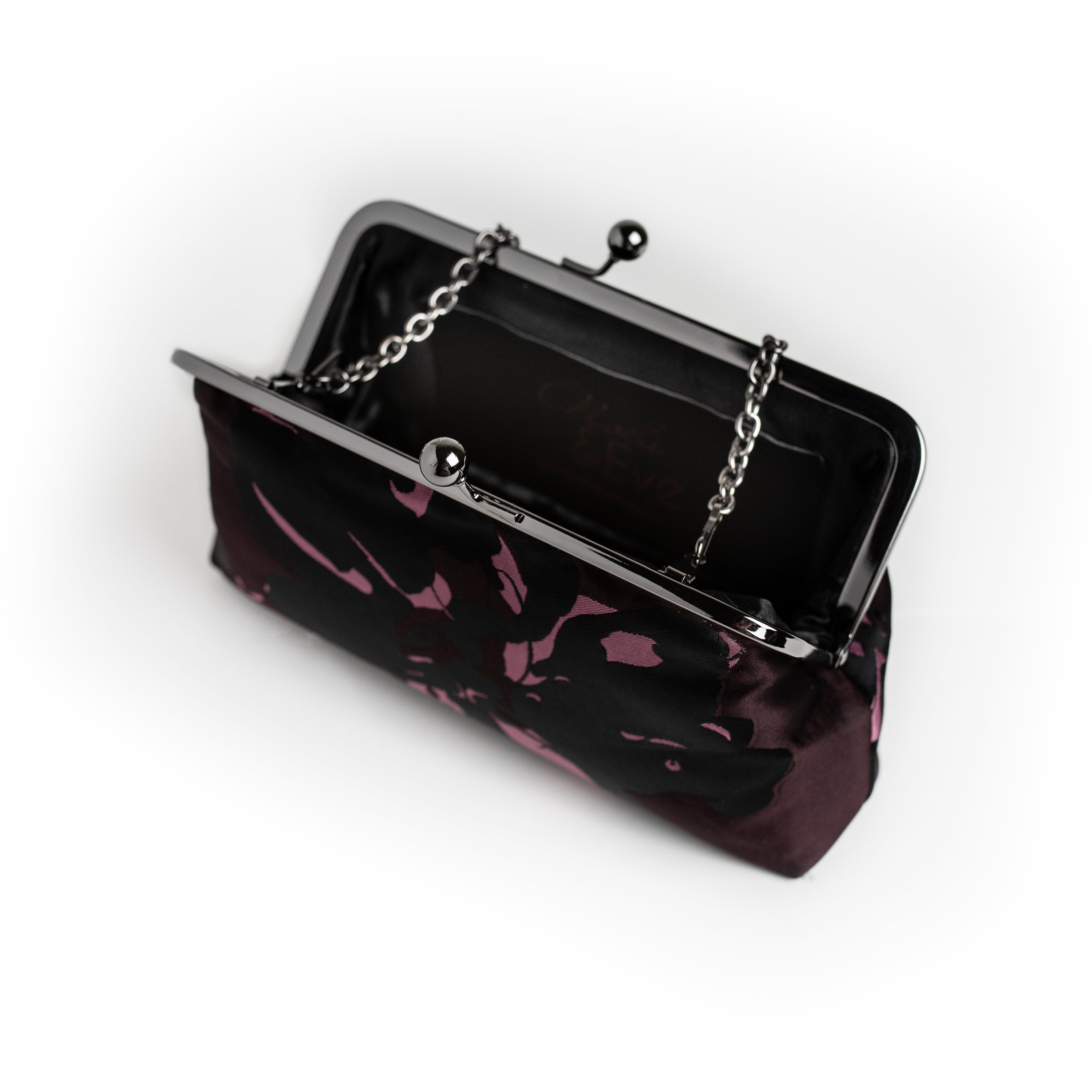 Black and Aubergine dual-tone floral brocade clutch by Nola & Eve with dual chain straps